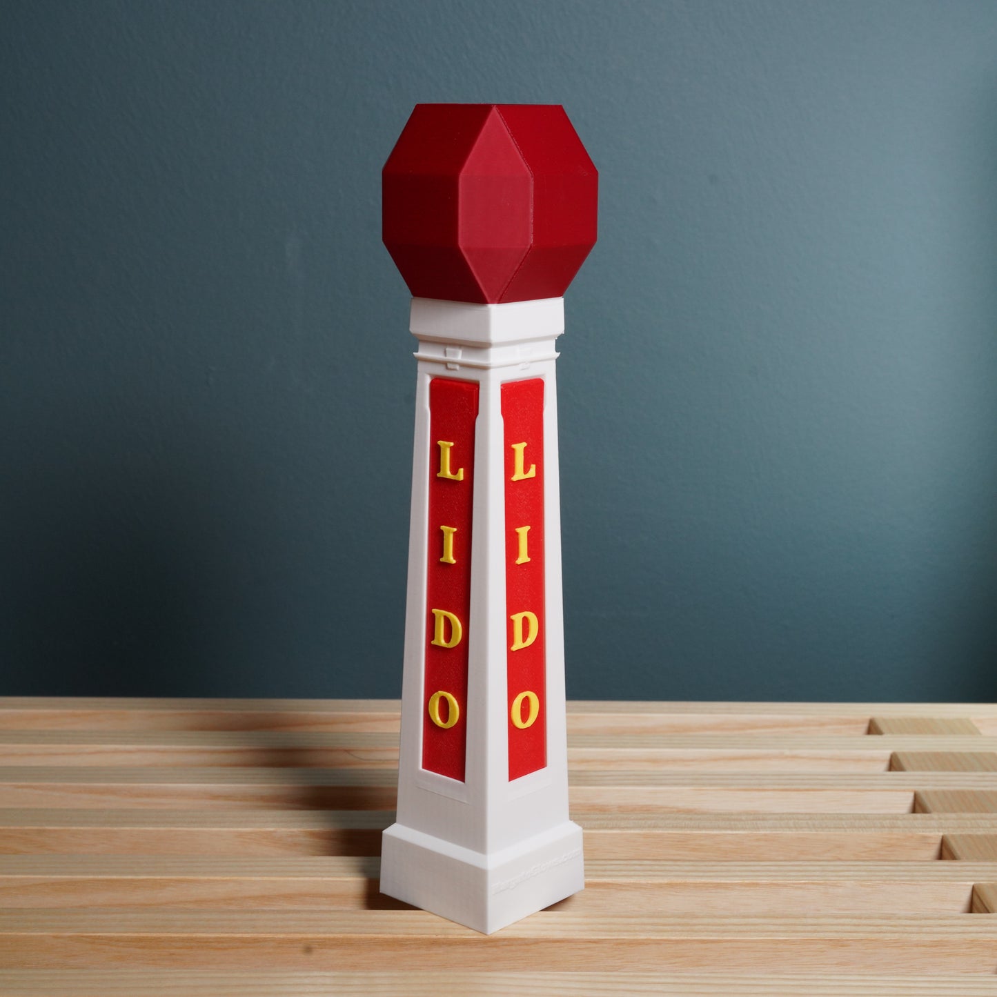 Decorative model of the Margate 'LIDO' branding on a wooden surface and gray background