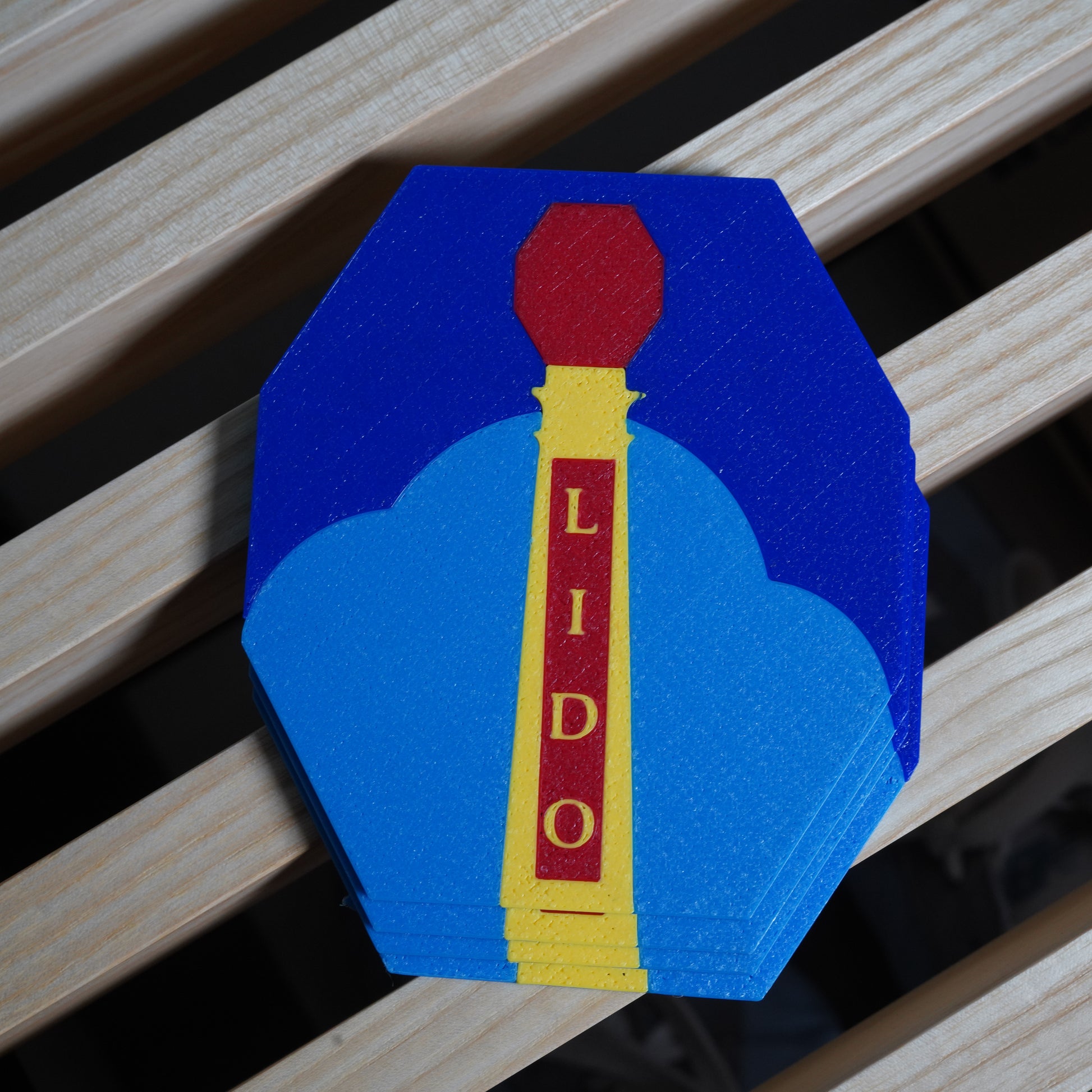 Colorful coaster with 'LIDO' text on a wooden surface