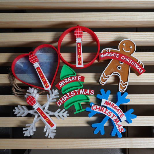 Set of Christmas-themed decorative items with 'Margate Christmas' text on a wooden surface.