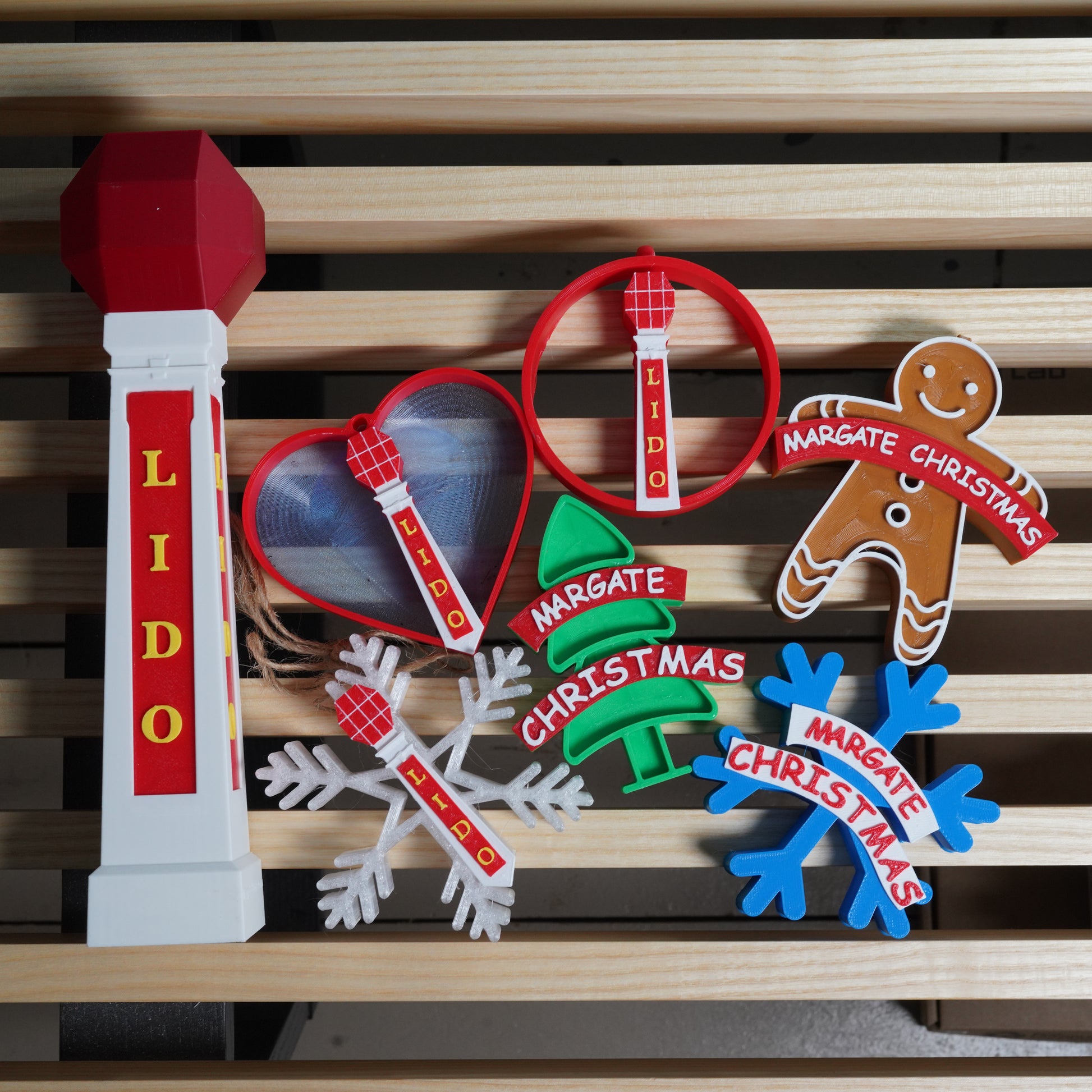 Set of Christmas-themed decorative items with 'Lido' and 'Margate Christmas' text on a wooden background.